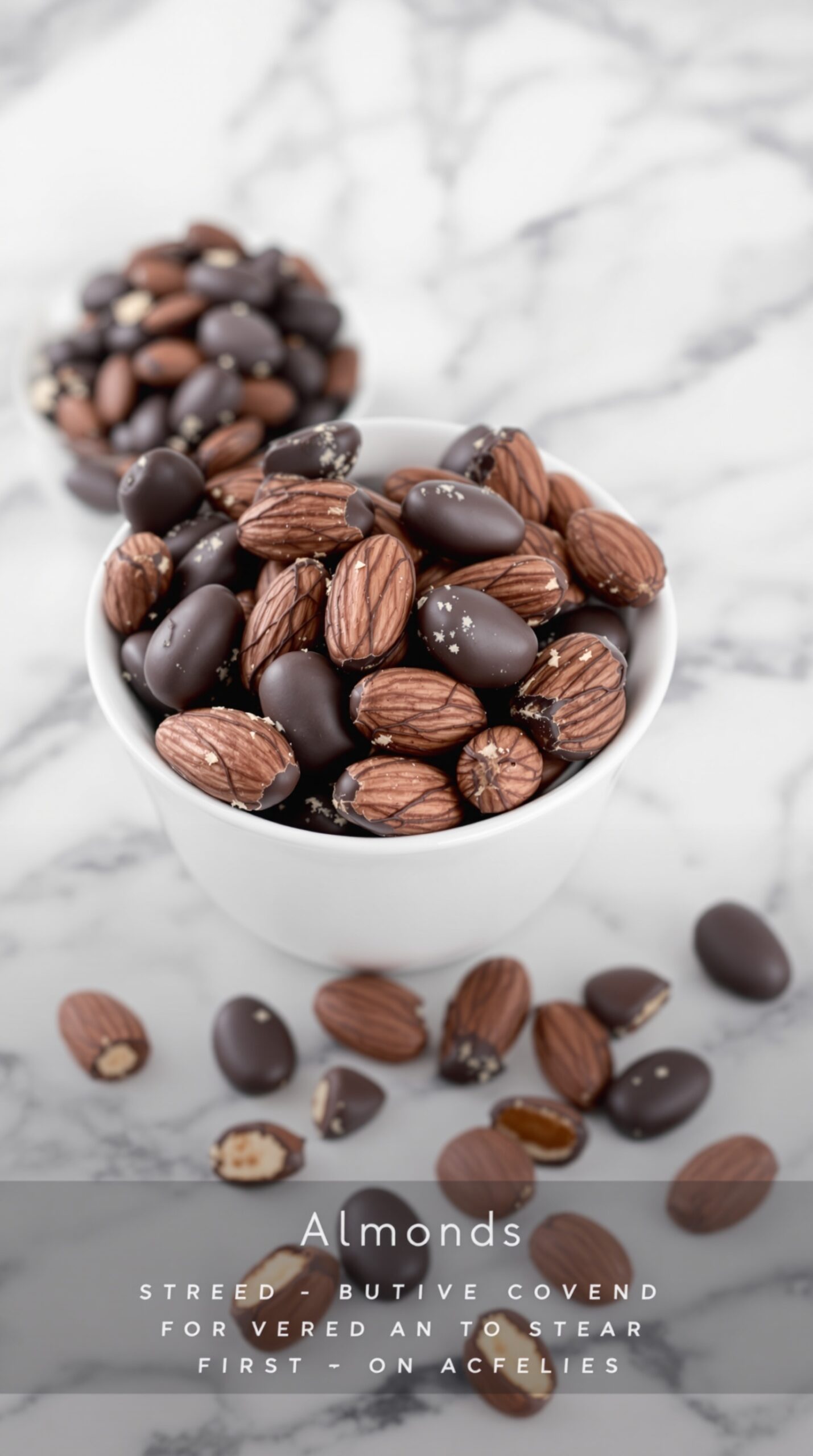 A bowl of dark chocolate covered almonds on a marble surface.