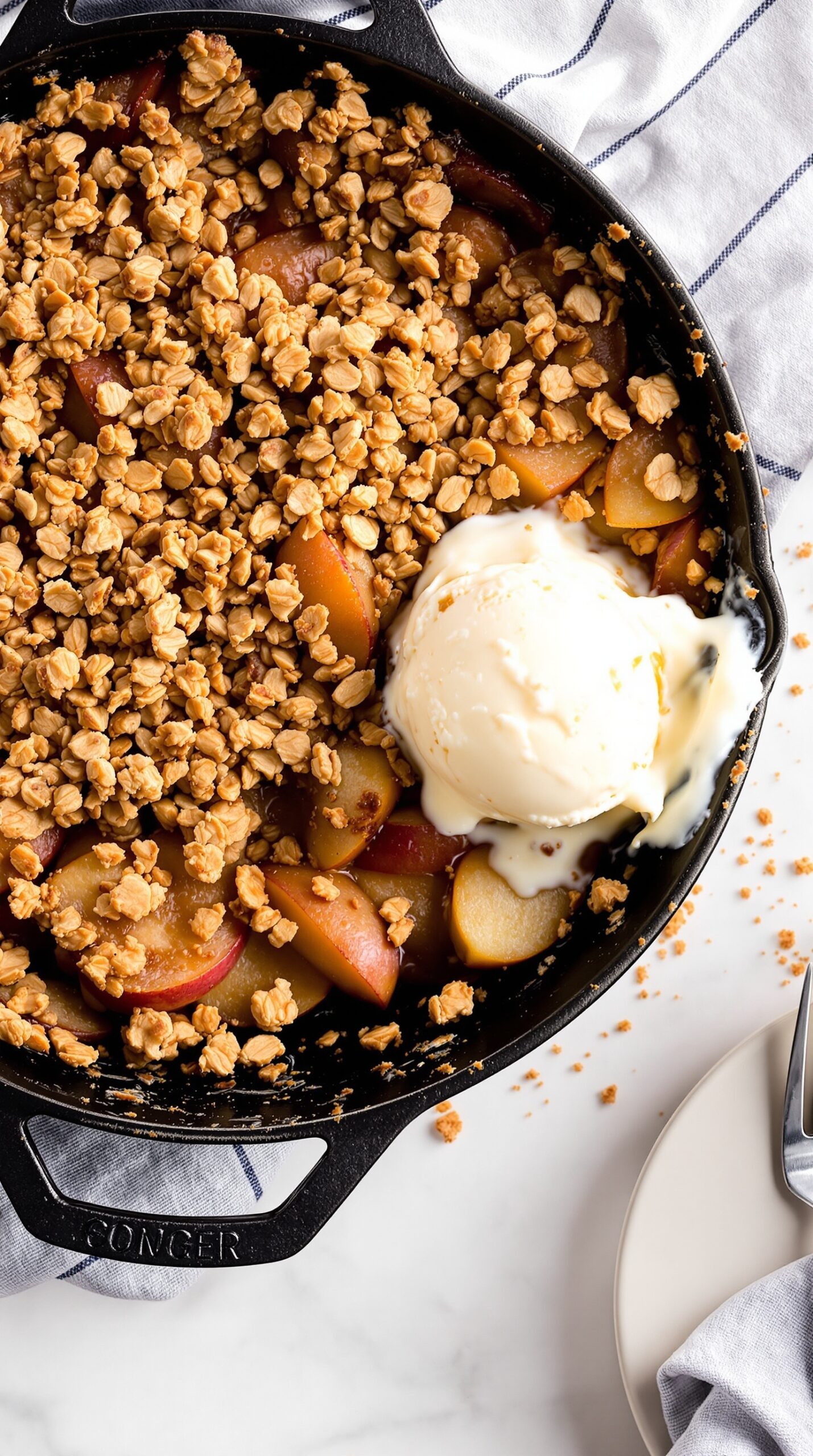 A delicious apple crisp with oat topping, served with a scoop of vanilla ice cream.